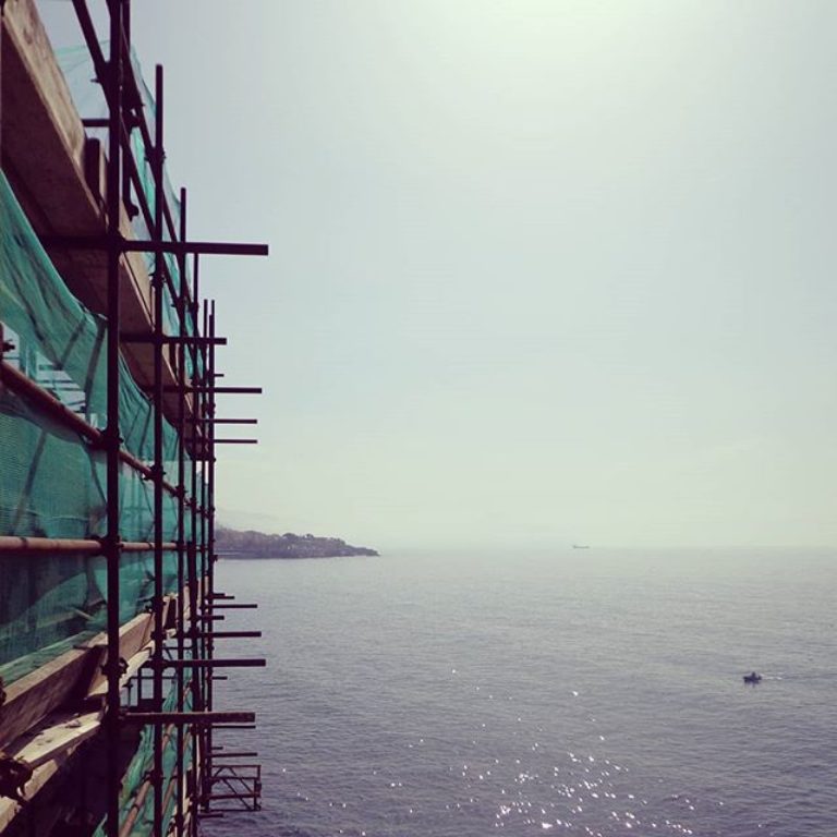 Facing the sea with spring blossoms. Scaffolding...